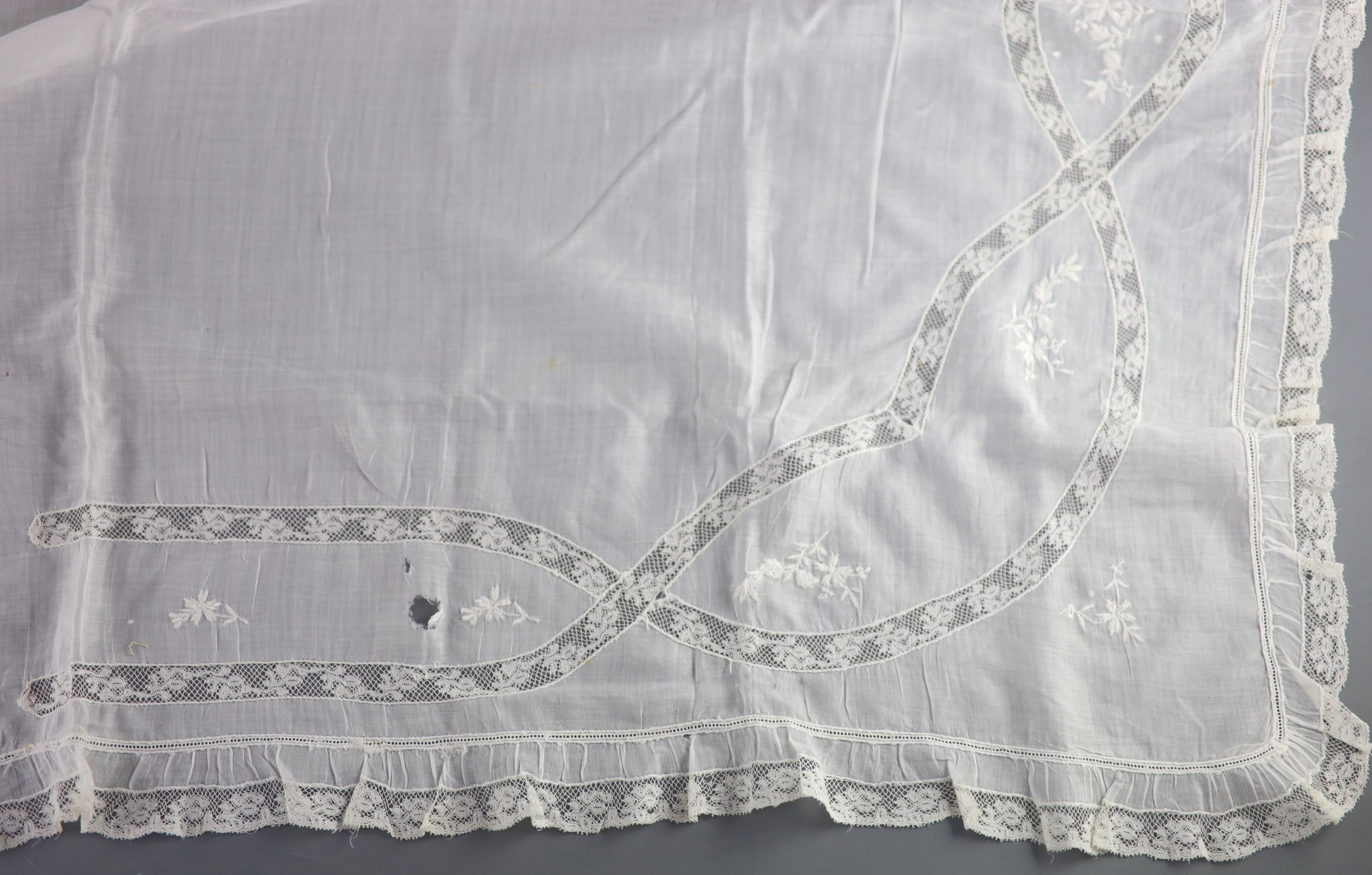 A fine white worked embroidered lace inset coverlet, a filet lace square of a figure wearing a crown (plus museum note),